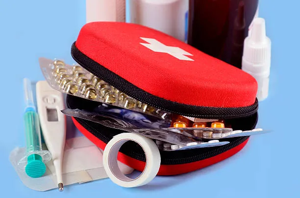 First Aid Kit With Medicines,pills,thermometer,plaster And Others On Blue Background